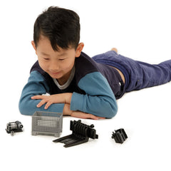 Child engaging with Bruder pallet and winch toy set, including forks and basket, on a white background.