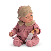 Bald doll in pink pajamas with mask, holding a bottle, seated with articulated limbs.