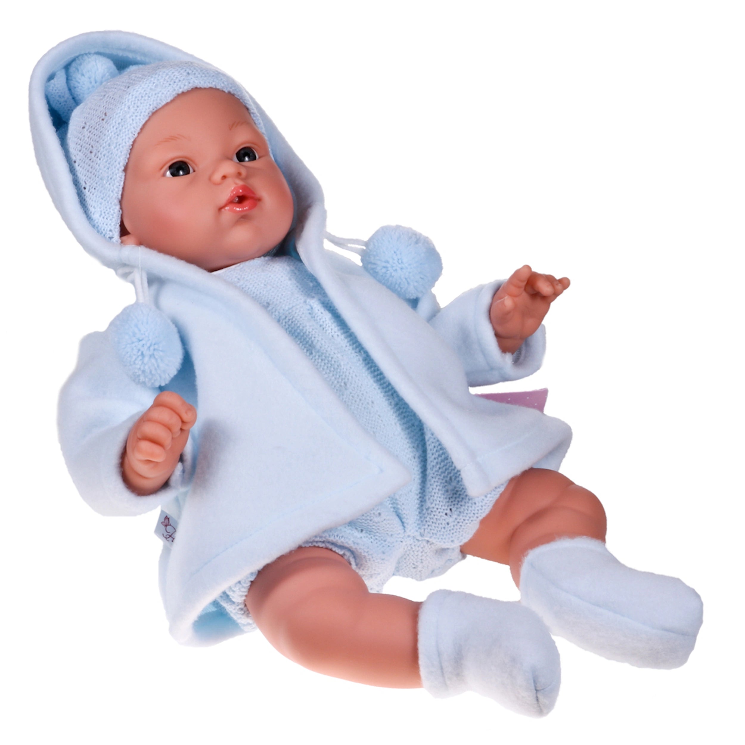 ASI Dolls Koke 36 cm wearing a soft blue outfit and hat with pom-poms, realistic features, lying on a white background.