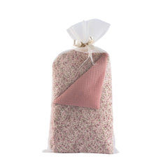 Quilted comforter and pillow set, floral pattern with pink accents, packaged in a sheer white bag with a ribbon.