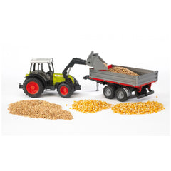 Bruder Claas Nectis 267 F tractor with red-tipped trailer, loading grains with front loader on white background.