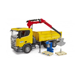 Yellow Scania construction truck toy with a red crane, blue attachment, and two wooden pallets on white background.