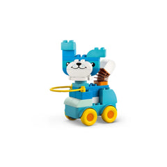 Blue and white LEGO animal figure, resembling a playful dog, on a yellow-wheeled base, featuring a flexible tail and cute facial features.