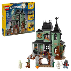 LEGO Creator 3in1 Haunted Mansion set featuring a spooky green house with ghostly figures, graveyard, and detailed accessories.