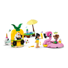Two LEGO Friends minidolls at a colorful pool party. One doll holds a popsicle near a pink flamingo floatie, while the other cheers. A pineapple-shaped bar serves drinks, with a cat figure inside. An umbrella and a beach chair complete the playful scene.
