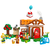 LEGO Animal Crossing Isabelle’s House Visit set featuring a colorful house, tree with red apples, and two characters engaging in playful activities.
