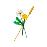 Colorful LEGO® Botanicals Field Flowers set featuring a dandelion, yellow flower, and wheat stalk, arranged with green leaves.