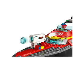 Red LEGO fireboat with a white water cannon and blue water element, showcasing detailed construction elements and bright colors.