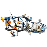 Colorful LEGO® Creator 3in1 Space Roller Coaster set features a winding track, dynamic carts, and space-themed elements like rockets and planets. Five minifigures interact within a vibrant amusement park scene, complete with a moon base and illuminated meteor, creating an immersive cosmic adventure.
