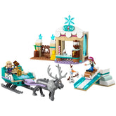 LEGO® Disney Frozen Anna's Sleigh Adventure set featuring Anna and Kristoff mini-dolls, Sven the reindeer, and Olaf on a sled, with a hot chocolate stand and a snow-themed hill.