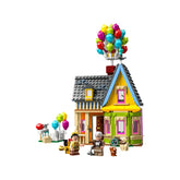 LEGO Disney Pixar 'Up' House construction set featuring a colorful house with balloons, Carl and Russell minifigures, and a Dug figure.