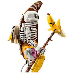 Lego Fortnite Peely Bone figure, 14 inches tall, combines a playful banana design with a skeleton aesthetic, holding a golden pickaxe.