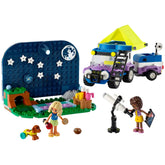 LEGO Friends Stargazing Camping Vehicle set features a colorful 4x4 vehicle with a camping trailer, two mini-dolls, a dog, and a telescope. A night sky backdrop includes planets and stars, enhancing the imaginative camping scene.