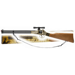 Gold-colored toy rifle with a wooden stock and mounted scope, resting on a textured surface.
