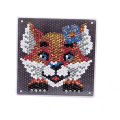 A decorative item featuring a vibrant, stylized fox face design with glossy surfaces and colorful accents.