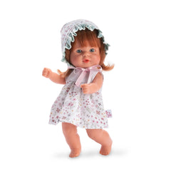 ASI Dolls Bomboncín Doll in floral dress with bonnet, standing with arms raised, showcasing red hair and a smiling expression.