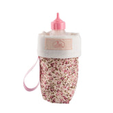 Pink floral doll bottle holder with a pink cap and ribbon loop.