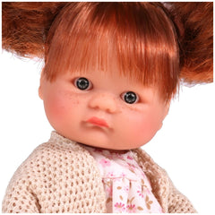 Red-haired doll with pigtails, blue eyes, and freckles, wearing a floral dress and knitted cardigan.