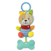 Baby Clementoni Lovely Soft Dog Rattle features a plush dog with a brown body, red bandana, and blue bone-shaped rattle.