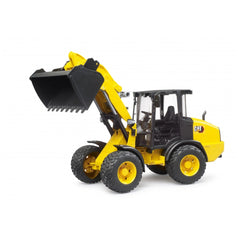 Yellow Bruder Cat Wheel Loader toy with articulated steering and raised black scoop.