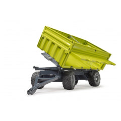 Bright green toy dumper with removable top, angled open, showing tires and steering axle on a white background.
