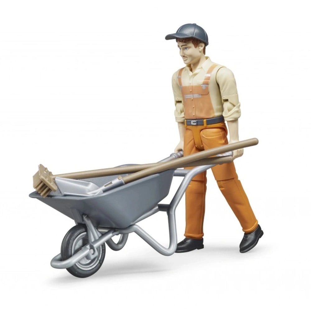 Municipal worker figure in orange overalls with a gray cap pushing a wheelbarrow containing tools.
