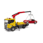 Yellow Bruder Scania tow truck with extendable red crane, lifting a red Bruder Roadster with loading harness.