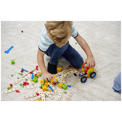 Eichhorn Constructor 3in1 construction set with wooden blocks and colorful connectors being assembled by a focused child.