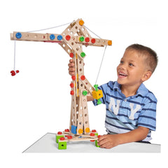 Eichhorn Constructor 5 in 1 set features a smiling child holding a colorful crane-like wooden structure at a white table.