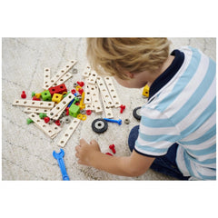 Eichhorn Constructor Expansion Set features a young boy playing with colorful wooden blocks and plastic connectors on a soft