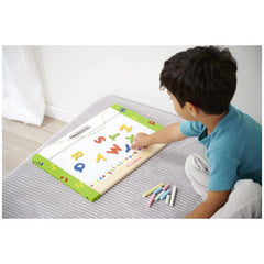 Eichhorn magnetic and chalkboard educational toy with a child arranging colorful letters on a floor mat.