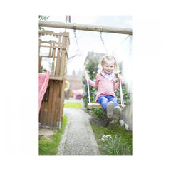 Eichhorn Outdoor Wooden Swing with a young girl in mid-swing, smiling, in a backyard setting with a cloudy sky.