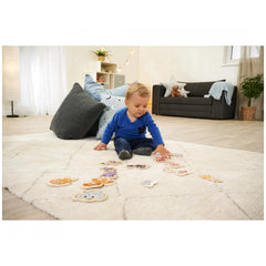 Eichhorn Wooden Animal Puzzle - A child plays with colorful blocks on a rug in a cozy home environment.