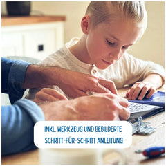 Eitech Rubin Rocket Racer Red Construction Set toy displayed as a child in a white shirt uses a laptop with an adult nearby.