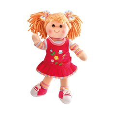 Heless Neli Soft Doll features a pale face, orange yarn hair, a floral red dress, and red shoes with white soles and laces.
