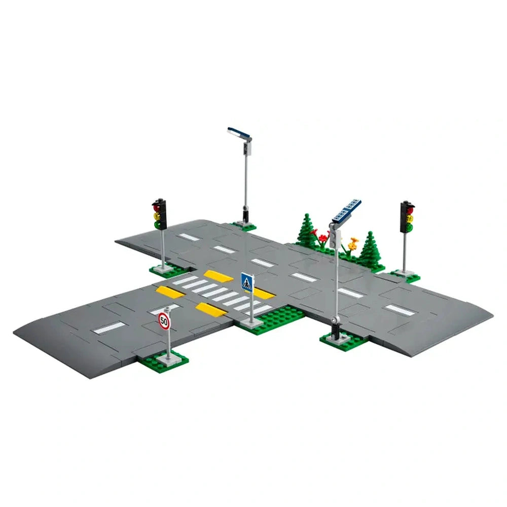 LEGO® City Road Plates construction set featuring a gray intersection with traffic lights, street signs, and landscaping elements.