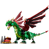 A colorful Lego Medieval Dragon with green and red wings, displaying posable limbs and a fierce expression, stands beside a treasure chest.