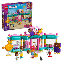 Colorful LEGO Friends Heartlake City Candy Store set with two mini-dolls and a cat figure, set against a vibrant backdrop.