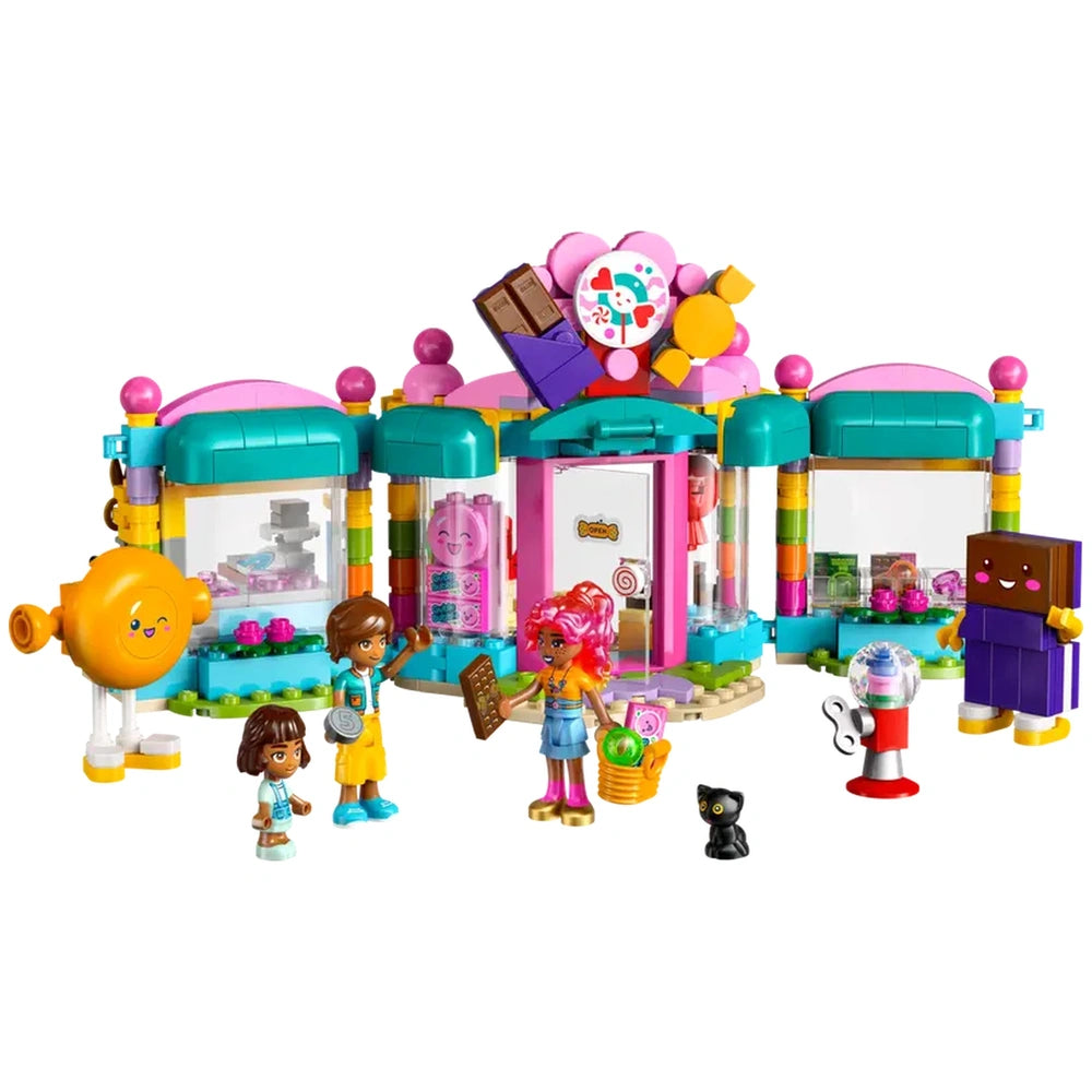 Heartlake City Candy Store set featuring colorful building, two mini-dolls, a micro-doll, and a playful cat figure in front.