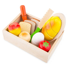 New Classic Toys Cuttingset includes a wooden box with plastic eggs, bread slices, and a toothbrush for role-playing breakfas