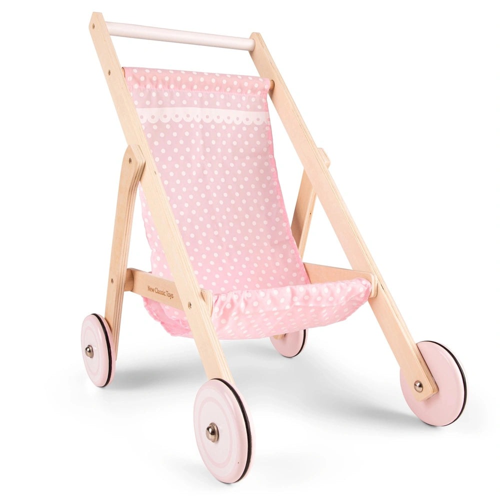Doll stroller with a wooden frame, pink fabric seat with white polka dots, and pink plastic wheels for pretend play.