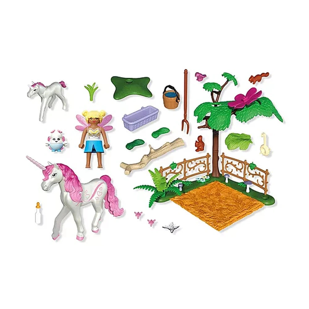 Playmobil Magical Unicorn Stable toy playset features pink and white unicorns, green tree, brown fence, and colorful accessor