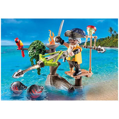 Playmobil Pirate-with-Ballista toy figure in pirate costume, holding sword and hook, set on a sandy beach with palm tree.