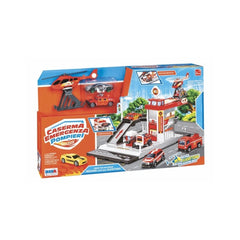 Fire station playset featuring a red roof, fire truck, yellow car, helicopter, and smaller emergency vehicles on a blue backg