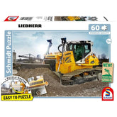 Schmidt Spiele's Bulldozer PR736 puzzle features a yellow Liebherr excavator on a construction site with a clear sky.