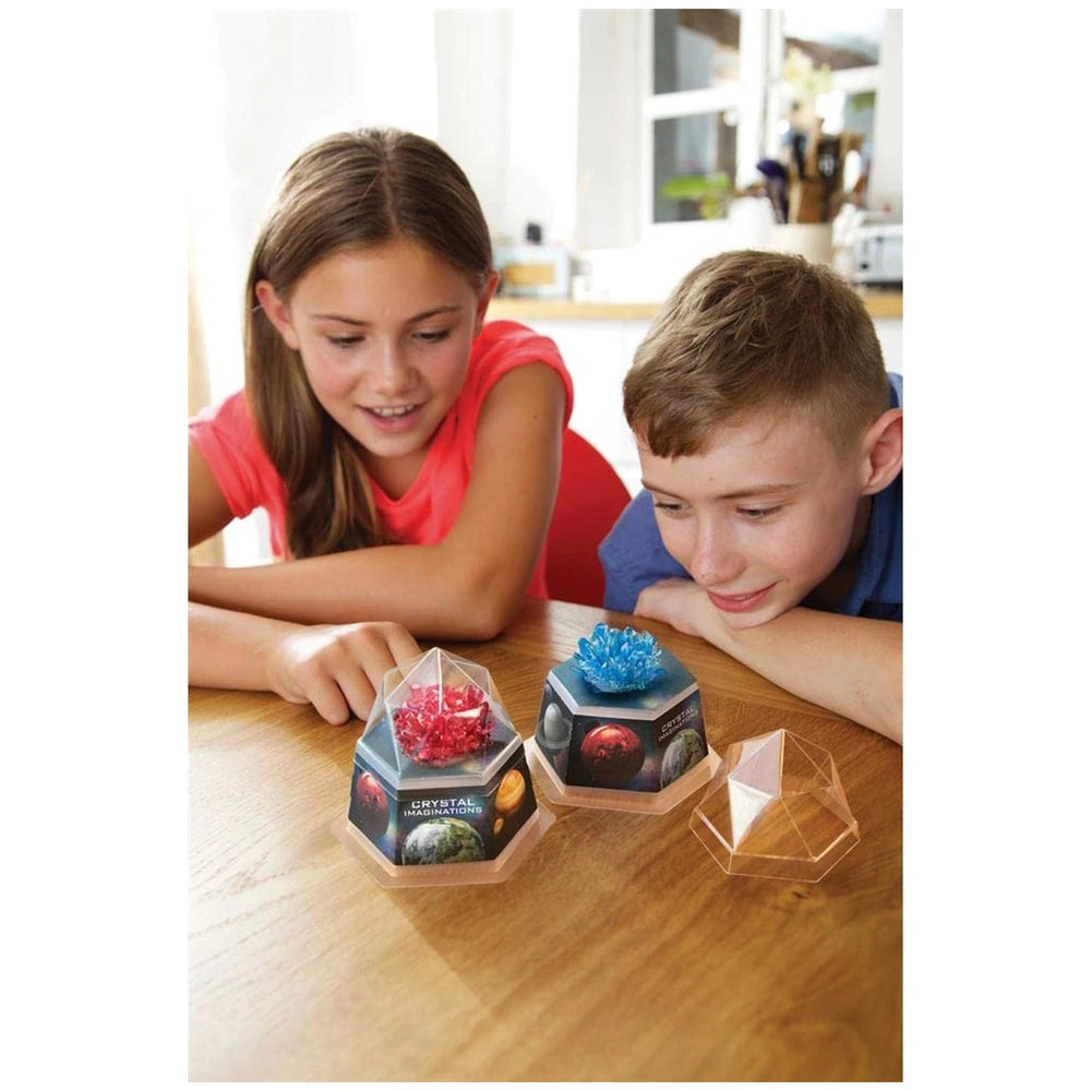 4M Crystal Growing Blue Edition toy playset displayed on a wooden table with children, featuring a clear plastic container.