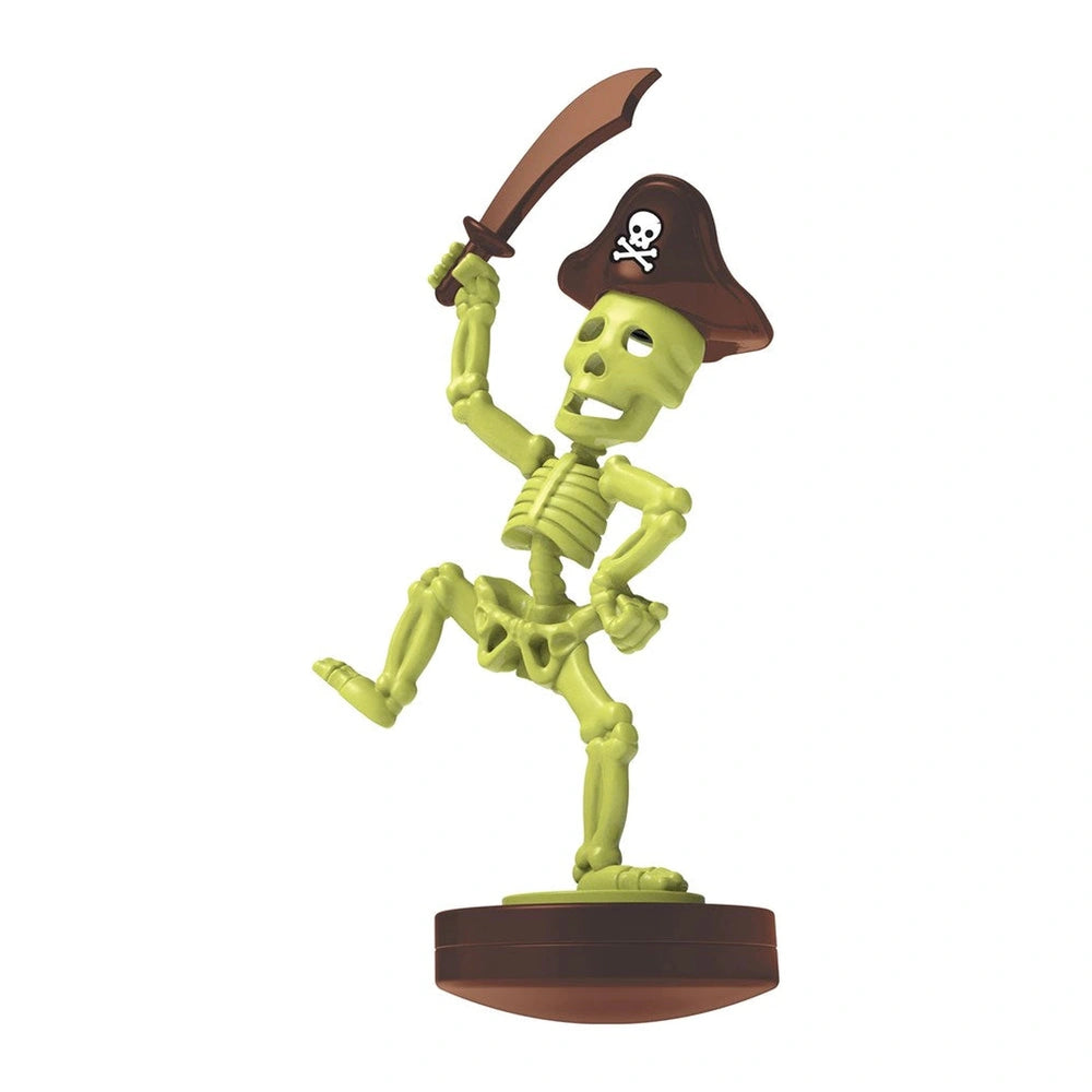 4M KidzLabs Dig Glow Pirate toy playset features a green skeleton, black pirate hat, white skull, and brown sword on a brown 