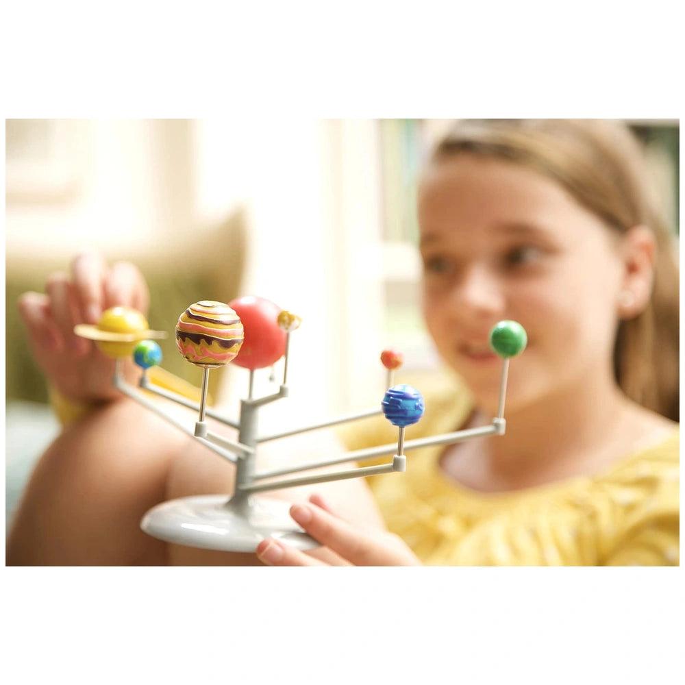 KidzLabs Planetarium educational toy features a girl in a yellow top holding a metallic stand with shiny red, yellow, and blu