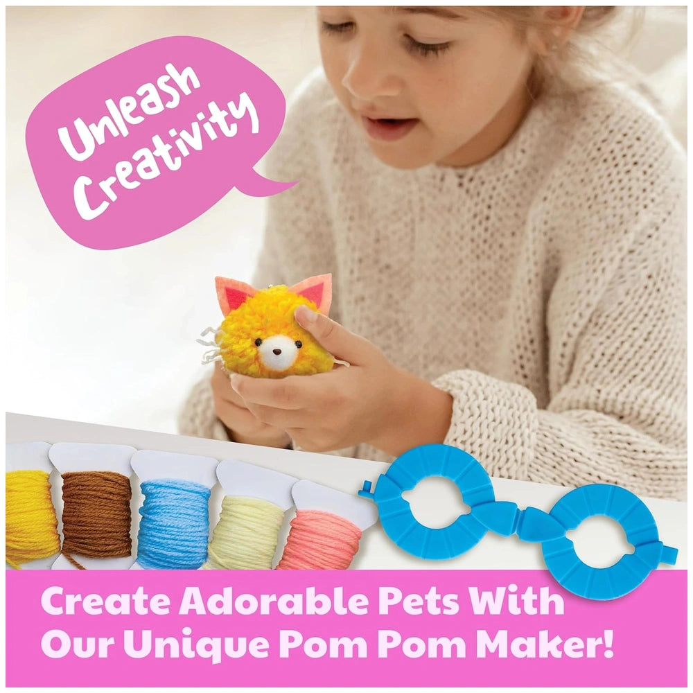 Young girl in a white sweater holds a blue pom pom maker, colorful yarn, and scissors while creating a plush toy.