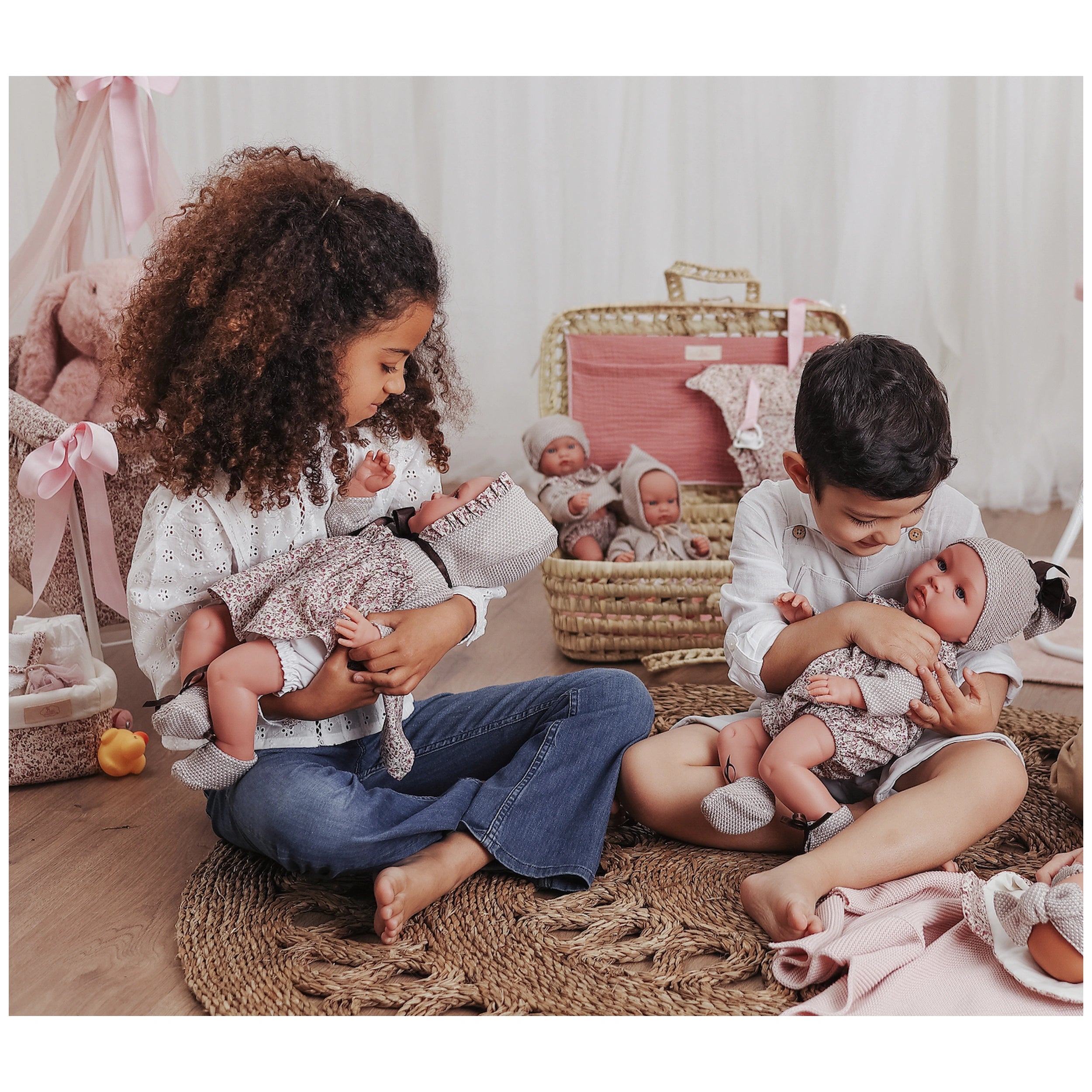 Children playing with ASI Dolls from the Leo Romper Martina Collection, showcasing stylish outfits and expressive eyes.